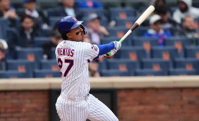 New York Mets' Mark Vientos (27) follows through on a RBI double during the sixth inning of a baseball game against the Washington Nationals Thursday, April 30, 2026, in New York. (AP Photo/Frank Franklin II)