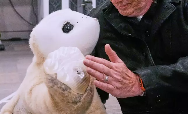 Colin Angle, co-founder and former CEO of Roomba vacuum maker, interacts with a prototype AI robot at his Massachusetts-based startup Familiar Machines &amp; Magic, Wednesday, April 29, 2026, in Woburn, Mass. (AP Photo/Charles Krupa)
