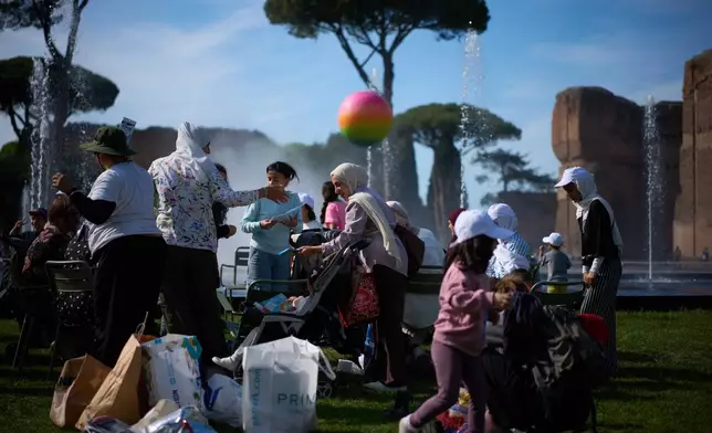 Families of Palestinian refugees who have arrived in Italy from the Gaza Strip through humanitarian corridors due to serious medical reasons, take part in a visit to Rome's Baths of Caracalla offered by the "Guides for Gaza" association, Sunday, May 3, 2026. (AP Photo/Andrew Medichini)
