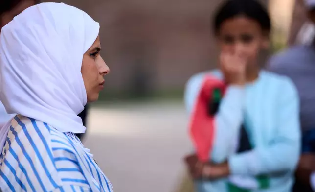 Mariam Dawwas is interviewed by The Associated Press during a visit to Rome's Baths of Caracalla offered by the "Guides for Gaza" association to around 50 Palestinian refugees who have arrived in Italy from the Gaza Strip through humanitarian corridors due to serious medical reasons, Sunday, May 3, 2026. (AP Photo/Andrew Medichini)