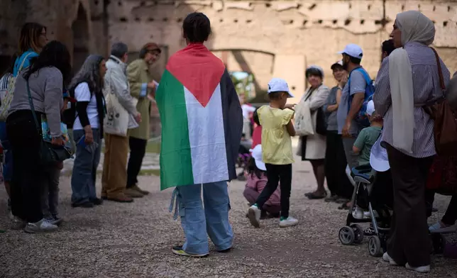 Families of Palestinian refugees who have arrived in Italy from the Gaza Strip through humanitarian corridors due to serious medical reasons take part in a visit to Rome's Baths of Caracalla offered by the "Guides for Gaza" association, Sunday, May 3, 2026. (AP Photo/Andrew Medichini)
