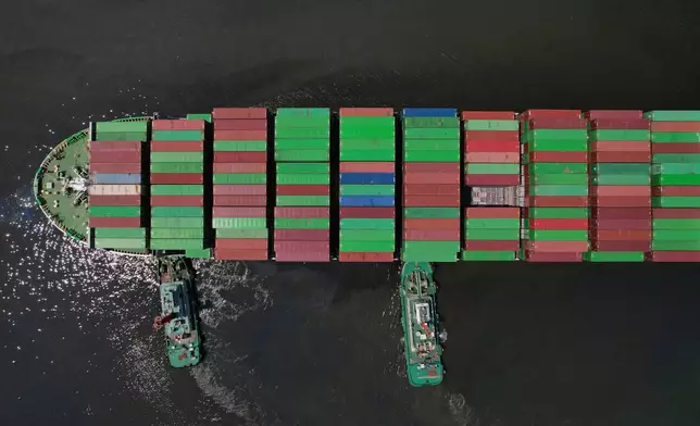 FILE - Tugboats assist a container ship as it prepares to dock at the Manila International Container Terminal at the Philippine capital April 8, 2025. (AP Photo/Aaron Favila, File)
