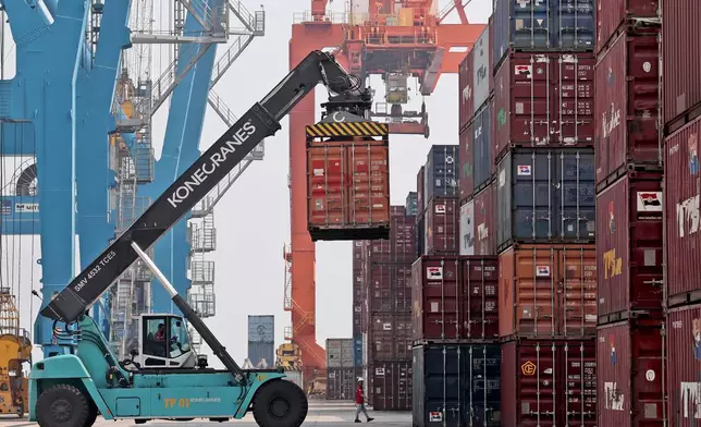 FILE - A stacker organizes containers at the terminal of Indonesia Port Corporations at the container Tanjung Priok Port in Jakarta, Indonesia, on Oct. 8, 2021. (AP Photo/Tatan Syuflana, File)