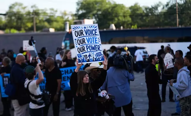 People protesting against Louisiana Governor Jeff Landry gather outside Orleans Parish criminal court on the day Calvin Duncan, an exoneree who was elected Orleans Parish clerk of criminal court, took his first day in office, Monday, May 4, 2026, in New Orleans. (AP Photo/Gerald Herbert)