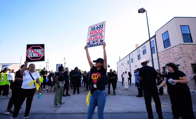 People protesting against Louisiana Governor Jeff Landry gather outside Orleans Parish criminal court on the day Calvin Duncan, an exoneree who was elected Orleans Parish clerk of criminal court, took his first day in office, Monday, May 4, 2026, in New Orleans. (AP Photo/Gerald Herbert)