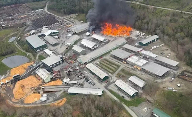 This photo provided by the Maine Department of Public Safety shows flames from a large fire at Robbins Lumber in Searsmont, Maine on Friday, May 15, 2026 (Maine Department of Public Safety via AP)