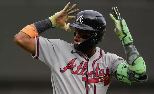 Atlanta Braves right fielder Ronald Acuña Jr. reacts as he round third base after hitting a solo home run during the first inning of a baseball game against the Cincinnati Reds in Cincinnati, Friday, May 29, 2026. (AP Photo/Carolyn Kaster)