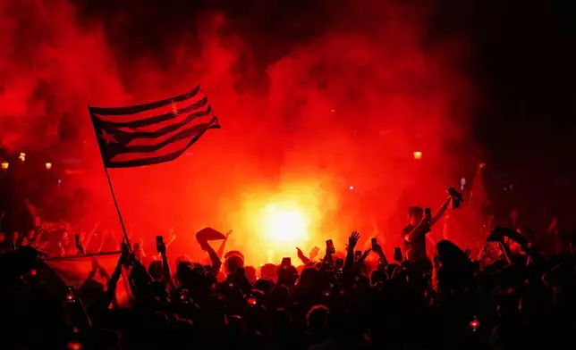FC Barcelona celebrate on the street after winning the Spanish La Liga soccer championship with three rounds to spare, in Barcelona, Spain, Sunday, May 10, 2026. (AP Photo/Joan Mateu Parra)