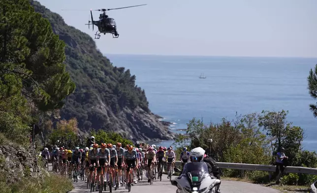 Riders pedal during the 11th stage of the Giro d'Italia cycling race, from Porcari to Chiavari, Italy, Wednesday May 20, 2026. (Marco Alpozzi/LaPresse via AP)
