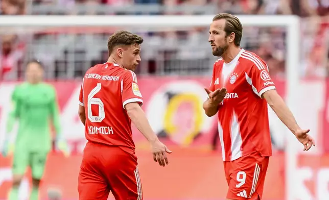 Bayern's Joshua Kimmich, left, and Harry Kane react during a German Bundesliga soccer match between Bayern Munich and 1. FC Heidenheim in Munich, Germany, Saturday, May 2, 2026. (Harry Langer/dpa via AP)