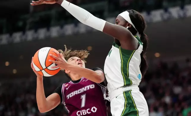 Toronto Tempo guard Kiki Rice (1) gets fouled by Seattle Storm centre Awa Fam (11) during the second half of a WNBA basketball game in Toronto, Saturday, May 30, 2026. (Frank Gunn/The Canadian Press via AP)