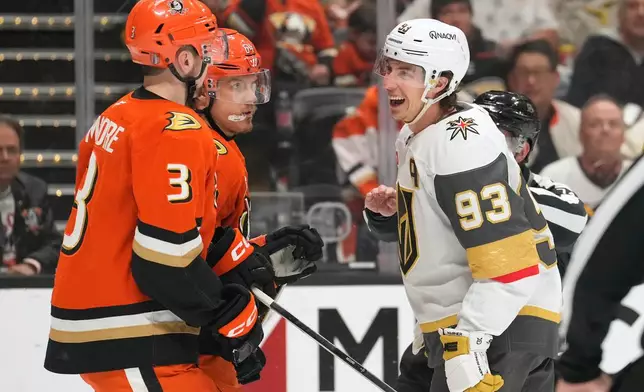 Vegas Golden Knights right wing Mitch Marner, right, laughs at Anaheim Ducks defenseman Ian Moore, left, and center Mikael Granlund during the second period in Game 6 of a second-round NHL hockey Stanley Cup playoff series Thursday, May 14, 2026, in Anaheim, Calif. (AP Photo/Mark J. Terrill)