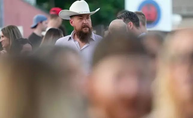 Alex Schamonin, standing at 6 feet, 6 inches tall looks over the crowd during a Tall Tour event Saturday, May 9, 2026, in Austin, Texas. (AP Photo/David J. Phillip)