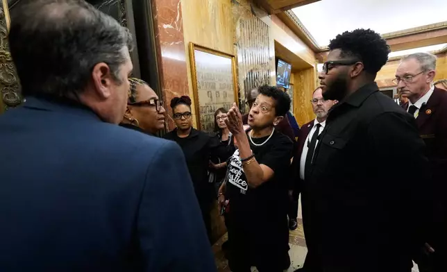A person opposed to the redistricting plan reacts as she leaves the Louisiana House chambers after the plan to eliminate a majority-Black congressional district, in response to a U.S. Supreme Court ruling, was passed in Baton Rouge, La., Thursday, May 28, 2026. (AP Photo/Gerald Herbert)
