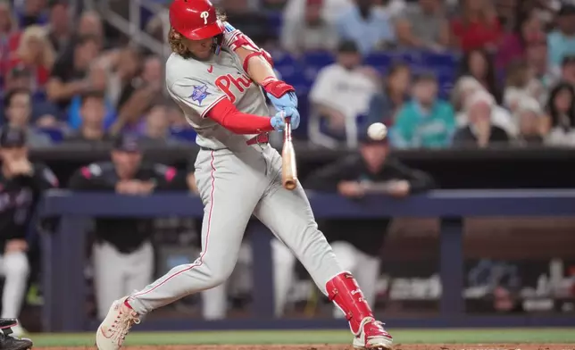 Philadelphia Phillies third baseman Alec Bohm (28) hits a single and drives in a run against the Miami Marlins during the fourth inning of a baseball game, Friday, May 1, 2026, in Miami. (AP Photo/Jim Rassol)