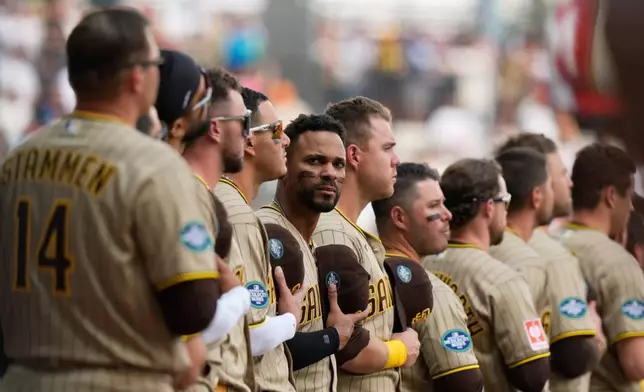 San Diego Padres' Xander Bogaerts, center, and teammate stand line prior to a baseball game against Arizona Diamondbacks in Mexico City, Saturday, April 25, 2026. (AP Photo/Fernando Llano)