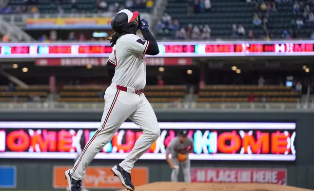 Minnesota Twins' Josh Bell, foreground, run the bases after hitting a two-run home run during the fourth inning of a baseball game against the Houston Astros, Monday, May 18, 2026, in Minneapolis. (AP Photo/Abbie Parr)