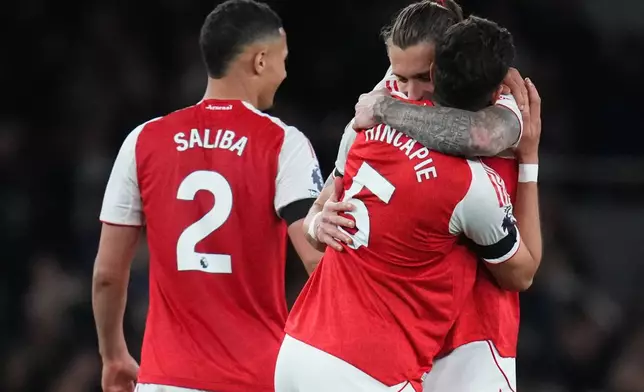 Arsenal's Riccardo Calafiori hugs Piero Hincapie after a Premier League soccer match between Arsenal and Burnley in London, Monday, May 18, 2026. (AP Photo/Kirsty Wigglesworth)