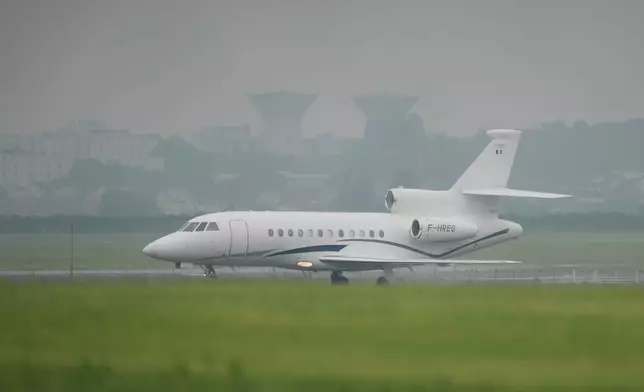 A plane carrying patients evacuated from the MV Hondius cruise ship with suspected hantavirus infection, lands at the Bourget airport, north of Paris, Sunday, May 10, 2026. (AP Photo/Thibault Camus)
