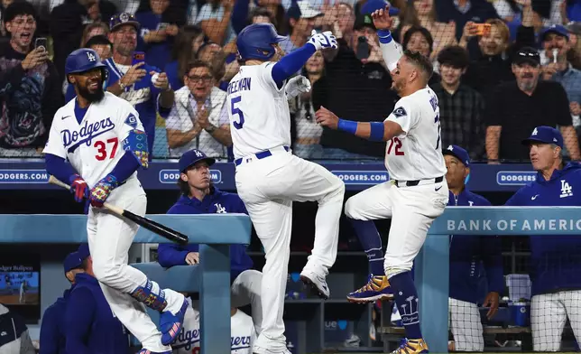 Los Angeles Dodgers' Freddie Freeman (5) and Miguel Rojas, right, celebrate after Freddie Freeman hits a home run as Teoscar Hernández (37) watches during the sixth inning of a baseball game against the Atlanta Braves, Friday, May 8, 2026, in Los Angeles. (AP Photo/Jessie Alcheh)