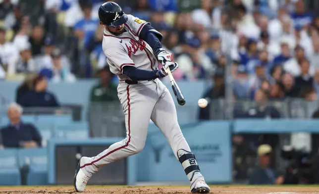Atlanta Braves' Austin Riley hits an RBI single during the second inning of a baseball game against the Los Angeles Dodgers, Friday, May 8, 2026, in Los Angeles. (AP Photo/Jessie Alcheh)