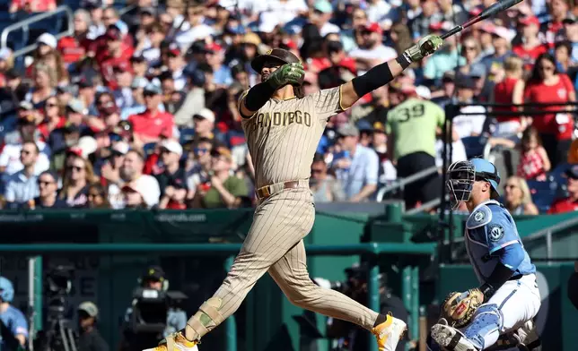 San Diego Padres' Fernando Tatis Jr. hits a home run during the fifth inning of a baseball game against the Washington Nationals, Saturday, May 30, 2026, in Washington. (AP Photo/Daniel Kucin Jr.)