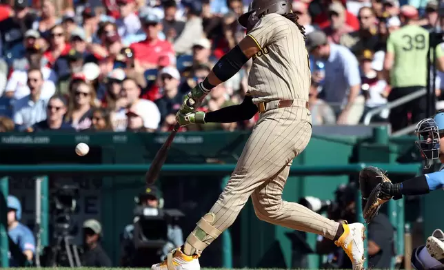 San Diego Padres' Fernando Tatis Jr. hits a home run during the fifth inning of a baseball game against the Washington Nationals, Saturday, May 30, 2026, in Washington. (AP Photo/Daniel Kucin Jr.)