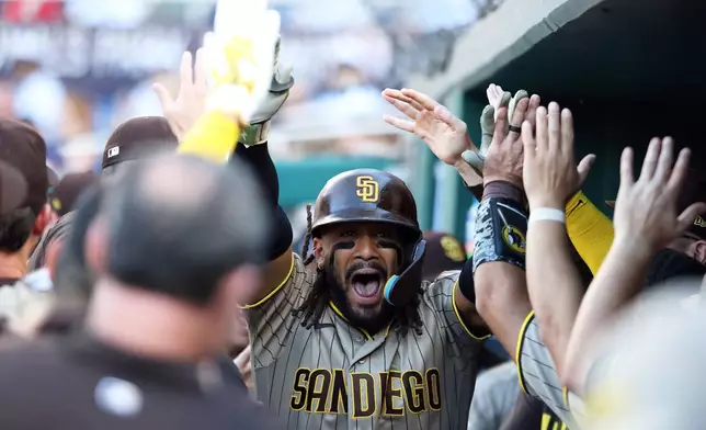 San Diego Padres' Fernando Tatis Jr. celebrates with his teammates after hitting a home run during the fifth inning of a baseball game against the Washington Nationals, Saturday, May 30, 2026, in Washington. (AP Photo/Daniel Kucin Jr.)