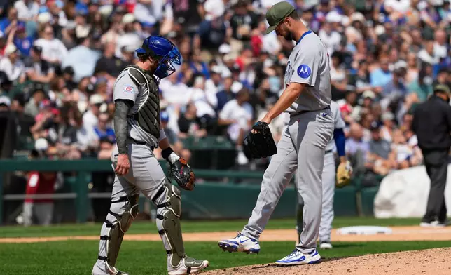 Chicago Cubs starting pitcher Colin Rea, right, kicks the mound as he talks with catcher Carson Kelly, left, during the fifth inning of a baseball game against the Chicago White Sox in Chicago, Sunday, May 17, 2026. (AP Photo/Nam Y. Huh)