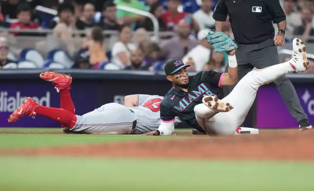 Washington Nationals' Curtis Mead (45) beats the throw to Miami Marlins third baseman Leo Jimenez, right, during the fifth inning of a baseball game, Friday, May 8, 2026, in Miami. (AP Photo/Lynne Sladky)