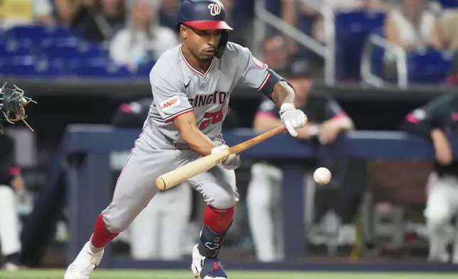 Washington Nationals' Nasim Nunez bunts on a ground out during the fourth inning of a baseball game against the Miami Marlins, Friday, May 8, 2026, in Miami. (AP Photo/Lynne Sladky)