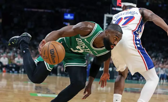 Boston Celtics' Jaylen Brown drives past the Philadelphia 76ers' VJ Edgecombe during the first half of Game 7 in a first-round NBA basketball playoffs series, Saturday, May 2, 2026 in Boston. (AP Photo/Jim Davis)