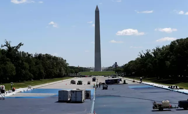 Workers apply a blue protective coating as part of a renovation project to the Lincoln Memorial Reflecting Pool, Friday, May 8, 2026, on the National Mall in Washington. (AP Photo/Rahmat Gul)
