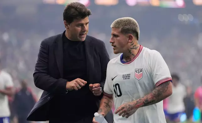 FILE - United States head coach Mauricio Pochettino, left, talks with midfielder Diego Luna (10) as they walk off the field at halftime of the team's CONCACAF Gold Cup final soccer match against Mexico in Houston, Sunday, July 6, 2025. (AP Photo/Ashley Landis, File)