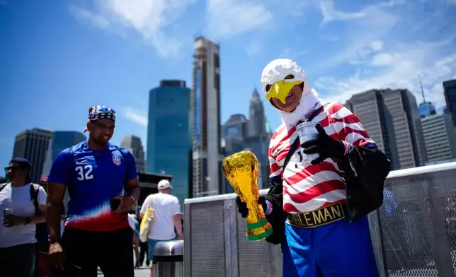 Marcus “Eagleman” Cranston, right, arrives for the announcement of the United States men's national soccer team roster, Tuesday, May 26, 2026, in New York, ahead of the FIFA World Cup soccer tournament. (AP Photo/Eduardo Munoz Alvarez)