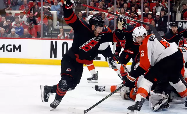 Carolina Hurricanes' Taylor Hall, left, celebrates after his winning overtime goal as Philadelphia Flyers' Travis Sanheim (6) looks on during Game 2 of an NHL hockey Stanley Cup second-round playoff series in Raleigh, N.C., Monday, May 4, 2026. (AP Photo/Karl DeBlaker)