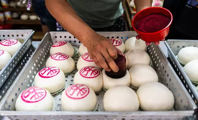 "Ping On" buns are prepared for sale for the Bun Festival in Cheung Chau Island in Hong Kong, Sunday, May 24, 2026. (AP Photo/Chan Long Hei)