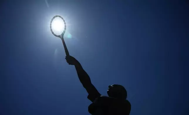 The sun shines over the statue of French tennis legend Jean Borotra at the French Open tennis tournament in Paris, Wednesday, May 27, 2026. (AP Photo/Christophe Ena)