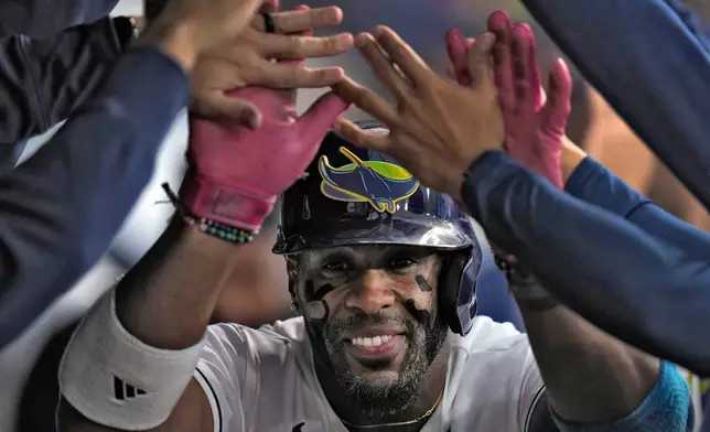 Tampa Bay Rays' Yandy DÌaz celebrates in the dugout after his solo home run off San Francisco Giants pitcher Robbie Ray during the second inning of a baseball game Friday, May 1, 2026, in St. Petersburg, Fla. (AP Photo/Chris O'Meara)