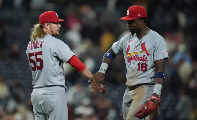 St. Louis Cardinals pitcher Ryne Stanek (55) celebrates with right fielder Jordan Walker after the Cardinals defeated the San Diego Padres 6-0 in a baseball game Friday, May 8, 2026, in San Diego. (AP Photo/Gregory Bull)