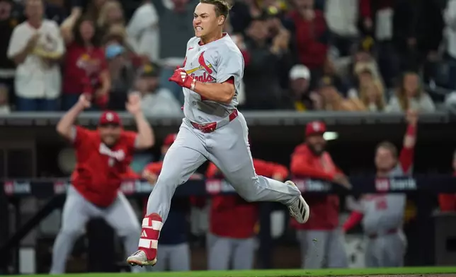 St. Louis Cardinals' JJ Wetherholt rounds third base, on his way to scoring after hitting a bases-loaded RBI single combined with a fielding error by San Diego Padres right fielder Fernando Tatis Jr. during the fifth inning of a baseball game Friday, May 8, 2026, in San Diego. Four runs scored on the play. (AP Photo/Gregory Bull)