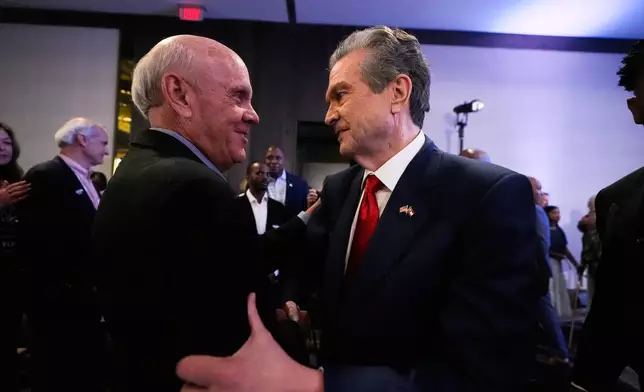 Georgia gubernatorial candidate Rick Jackson talks to a supporter after speaking during a primary election night party on Tuesday, May 19, 2026, in Atlanta. (AP Photo/Brynn Anderson)