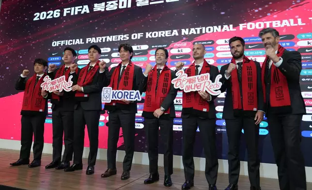 South Korea's national soccer team head coach Hong Myung-bo, fourth from left, poses with team coaches for the media after a news conference announcing South Korea's squad for the 2026 FIFA World Cup in Seoul, South Korea, Saturday, May 16, 2026. (AP Photo/Lee Jin-man)
