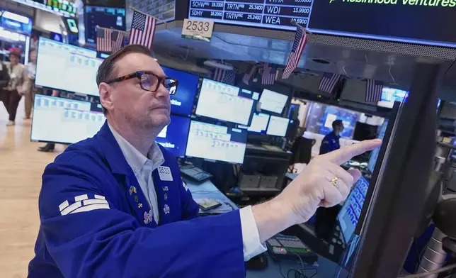 Specialist Patrick King works at his post on the floor of the New York Stock Exchange, Friday, May 1, 2026. (AP Photo/Richard Drew)