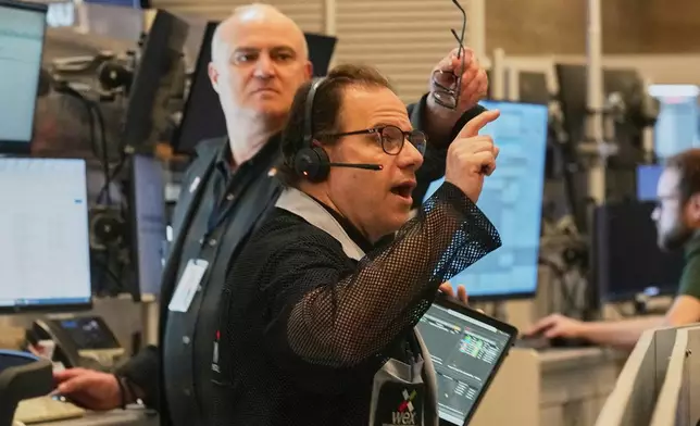 Options trader Anthony Spina, foreground, works on the floor of the New York Stock Exchange, Thursday, April 30, 2026. (AP Photo/Richard Drew)