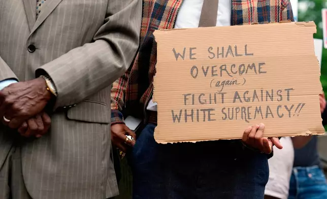 A person holds a sign during news conference before a special session of the state legislature to redraw U.S. Congressional voting maps Tuesday, May 5, 2026, in Nashville, Tenn. (AP Photo/George Walker IV)