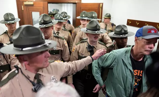 State troopers clear a House committee meeting after it was disrupted by protesters during a special session of the state legislature to redraw U.S. Congressional voting maps Wednesday, May 6, 2026, in Nashville, Tenn. (AP Photo/George Walker IV)