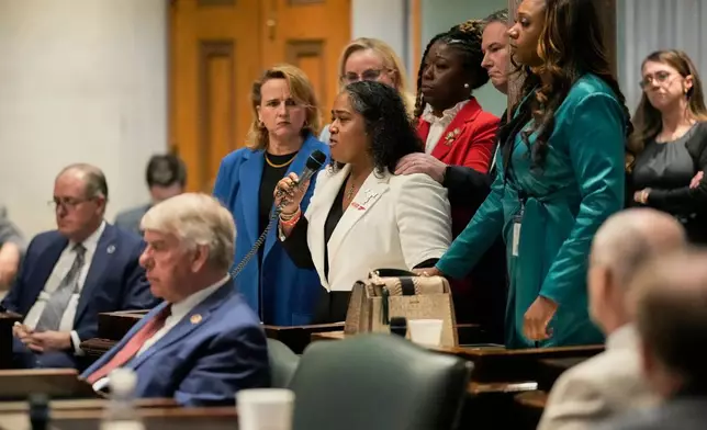 Sen. Raumesh Akbari, D-Memphis, center, speaks on the floor of the Senate chamber with other Democrat senators by her side during a special session of the state legislature to redraw U.S. Congressional voting maps, in Nashville, Tenn. , Tuesday, May 5, 2026. (AP Photo/George Walker IV)
