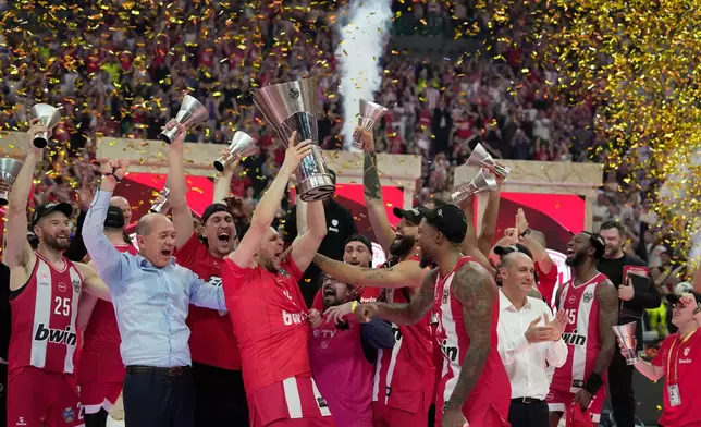 Olympiacos' Kostas Papanikolaou lifts the trophy after winning the Euroleague final basketball match against Real Madrid in Athens, Greece, Sunday, May 24, 2026. (AP Photo/Thanassis Stavrakis)