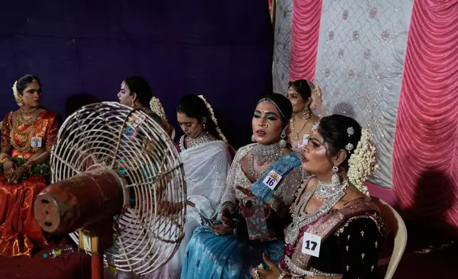 Transgender participants wait before taking part in Miss Koovagam 2026 beauty pageant during Koovagam festival, in Villupuram, India, Monday, April 27, 2026. (AP Photo/Mahesh Kumar A.)